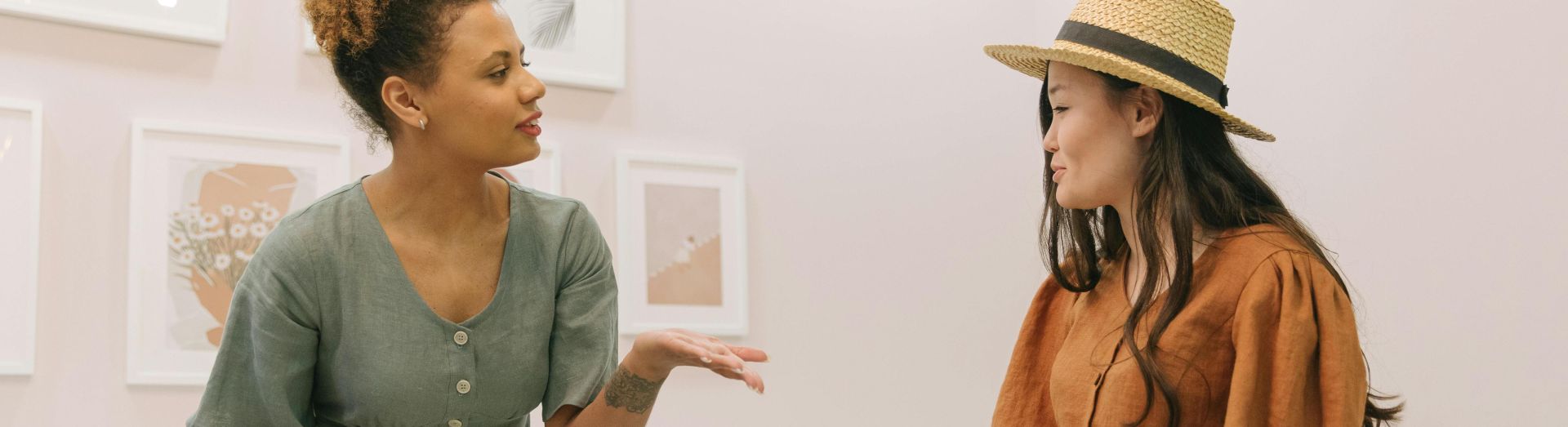 Two women fashion designers discussing and planning together in a stylish indoor setting